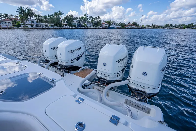  Yacht Photos Pics 2019 Freeman 42LR boat with four powerful outboard engines on a scenic waterfront.