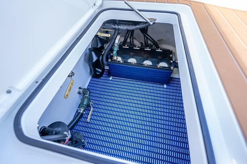  Yacht Photos Pics Freeman 42LR 2019 boat compartment with mechanical components and blue mat.