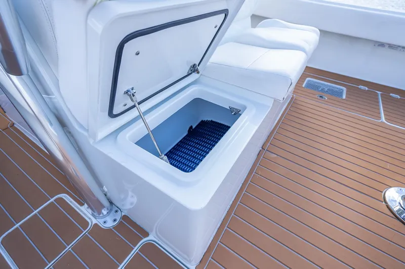  Yacht Photos Pics Open storage compartment on 2019 Freeman 42LR boat with cushioned seating.