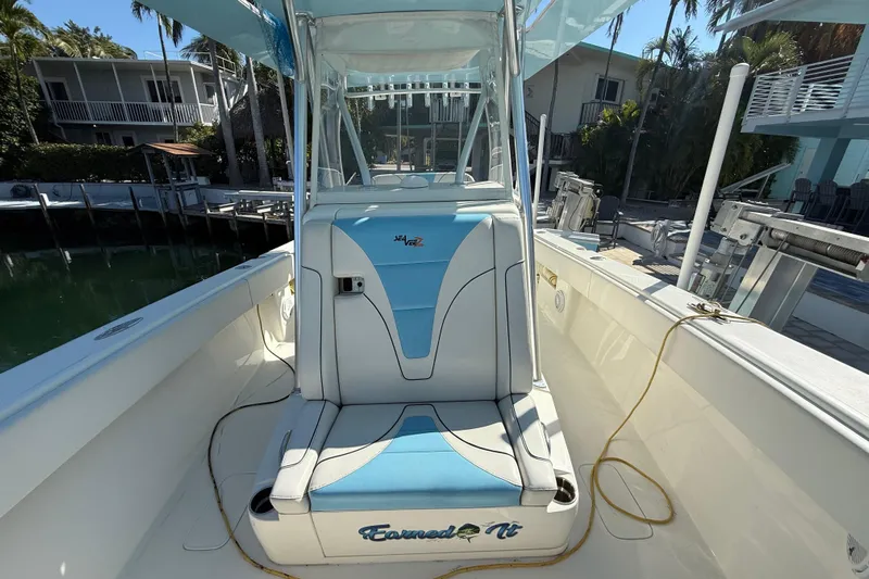  Yacht Photos Pics 2019 SeaVee 340Z boat interior with blue and white seating, docked near waterfront homes.