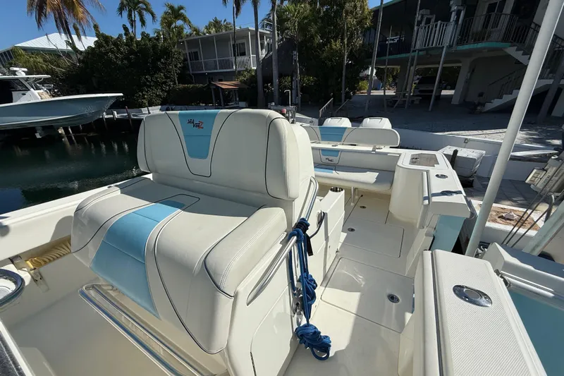  Yacht Photos Pics 2019 SeaVee 340Z boat interior with seating, docked near tropical trees.