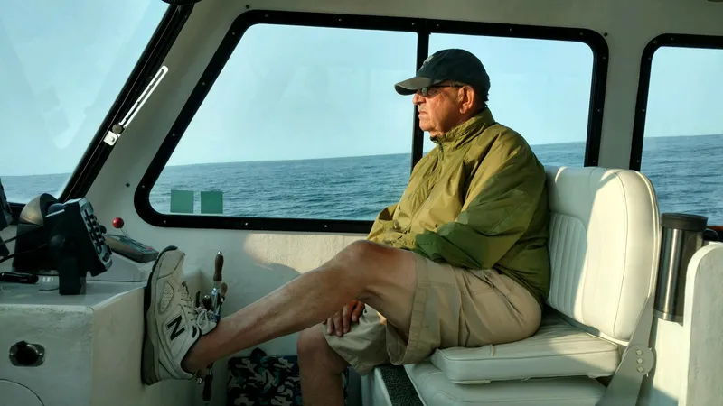  Yacht Photos Pics Man relaxing on a 2002 Northern Bay Fisherman/Cruiser boat at sea.