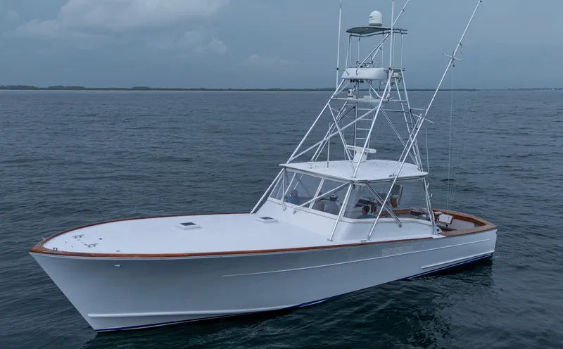 Slippery Slope Yacht Photos Pics 2005 Gamefisherman 45 Express boat on open water, featuring sleek design and fishing tower.