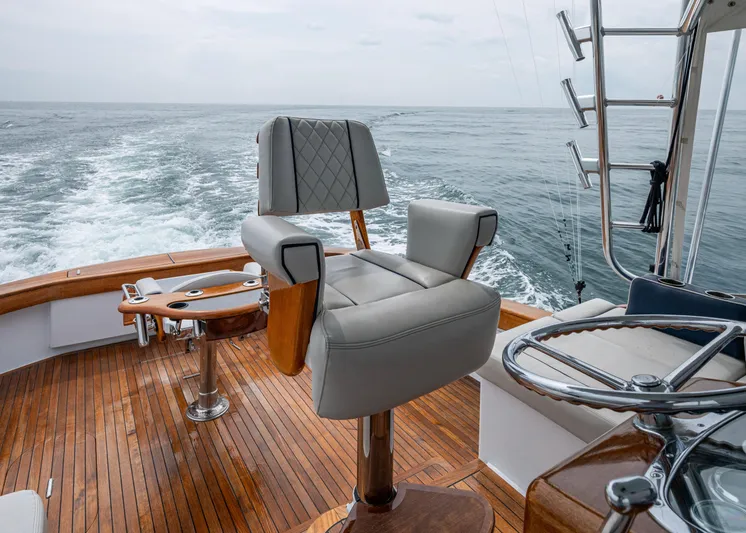 Slippery Slope Yacht Photos Pics 2005 Gamefisherman 45 Express boat with helm chair and fishing rod holders on teak deck.