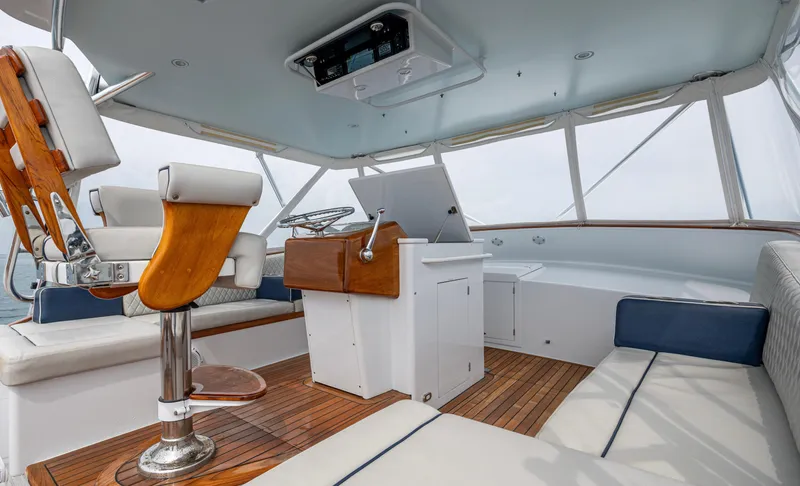 Slippery Slope Yacht Photos Pics 2005 Gamefisherman 45 Express boat interior with wooden helm and seating.