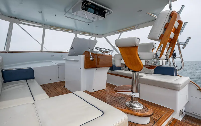 Slippery Slope Yacht Photos Pics 2005 Gamefisherman 45 Express boat interior with wooden deck and cushioned seating.