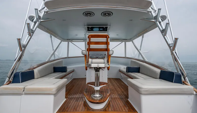 Slippery Slope Yacht Photos Pics 2005 Gamefisherman 45 Express boat interior with seating and helm, featuring wooden deck.