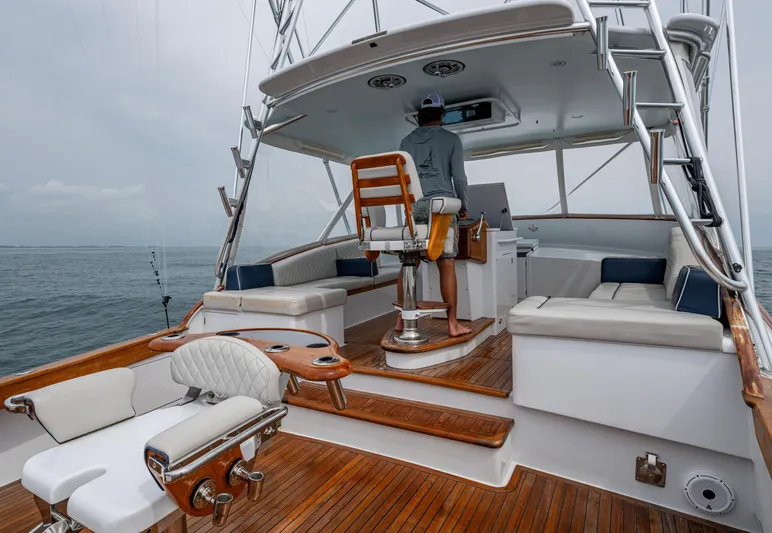 Slippery Slope Yacht Photos Pics 2005 Gamefisherman 45 Express yacht interior with wooden deck and seating, ocean view.