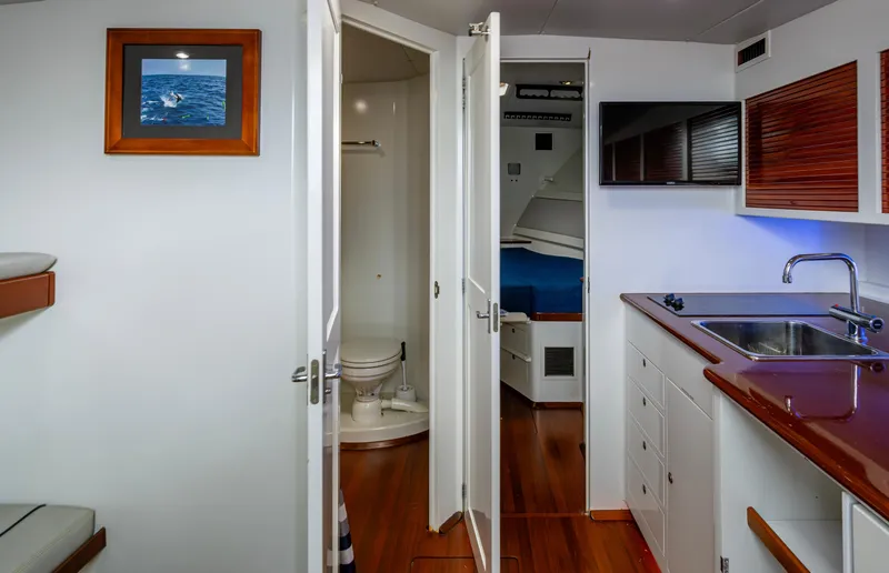 Slippery Slope Yacht Photos Pics Interior of 2005 Gamefisherman 45 Express yacht with kitchenette, bathroom, and cabin.