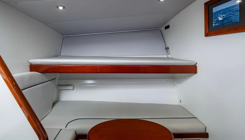 Slippery Slope Yacht Photos Pics 2005 Gamefisherman 45 Express cabin interior with bunk beds and framed ocean photo.