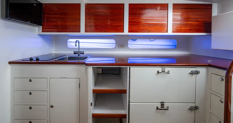 Slippery Slope Yacht Photos Pics 2005 Gamefisherman 45 Express yacht interior kitchen with wooden cabinets and modern appliances.