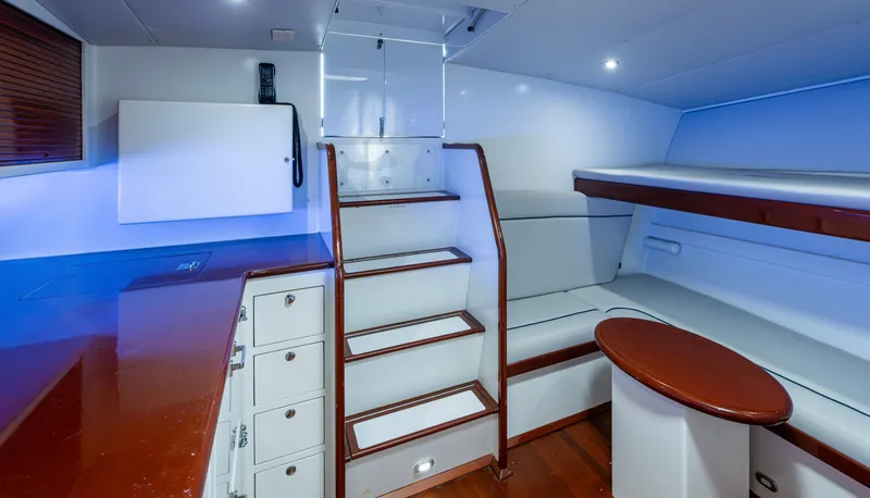 Slippery Slope Yacht Photos Pics Interior of 2005 Gamefisherman 45 Express yacht, featuring stairs, seating, and storage.