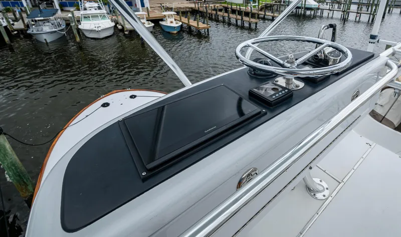 Slippery Slope Yacht Photos Pics Helm of 2005 Gamefisherman 45 Express boat with steering wheel and navigation equipment.