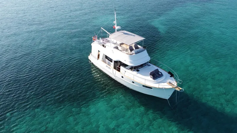 Libertad Yacht Photos Pics 2020 Beneteau Swift Trawler 44 on clear blue water, aerial view.