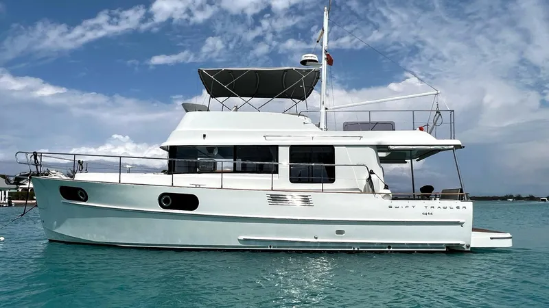 Libertad Yacht Photos Pics 2020 Beneteau Swift Trawler 44 on calm turquoise water under a partly cloudy sky.