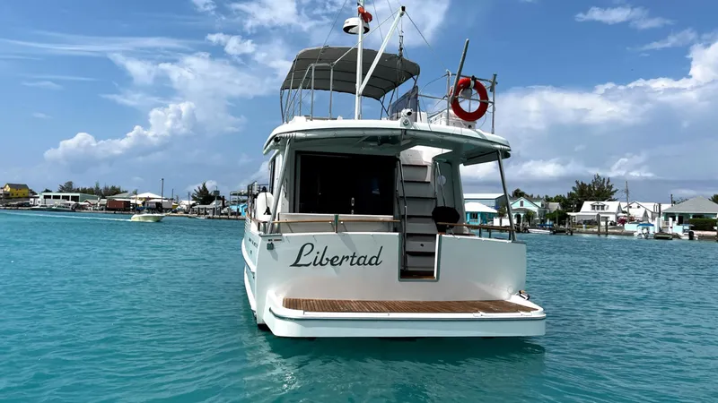 Libertad Yacht Photos Pics Beneteau Swift Trawler 44, 2020 model, named "Libertad" on turquoise water, clear sky.