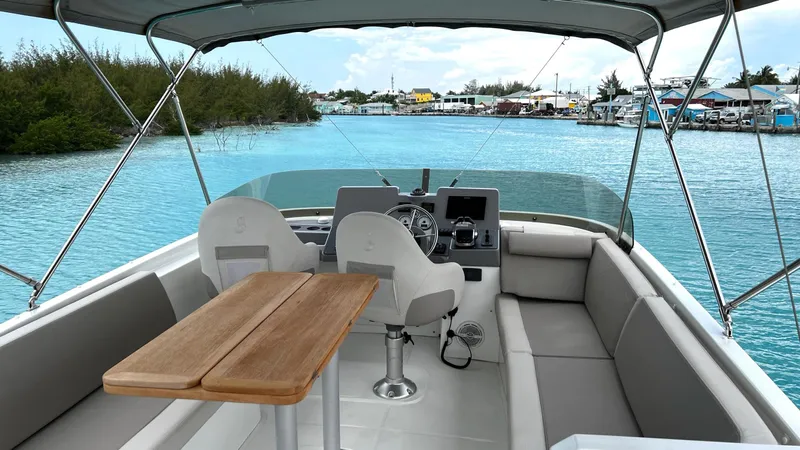 Libertad Yacht Photos Pics 2020 Beneteau Swift Trawler 44 interior with helm, seating, and table on calm water.