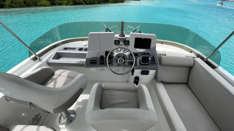 Libertad Yacht Photos Pics Flybridge of 2020 Beneteau Swift Trawler 44 with modern controls and seating, overlooking turquoise water.
