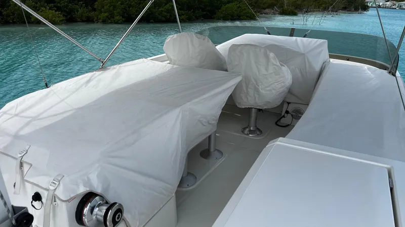 Libertad Yacht Photos Pics Beneteau Swift Trawler 44, 2020 model, covered seating area on deck by turquoise water.