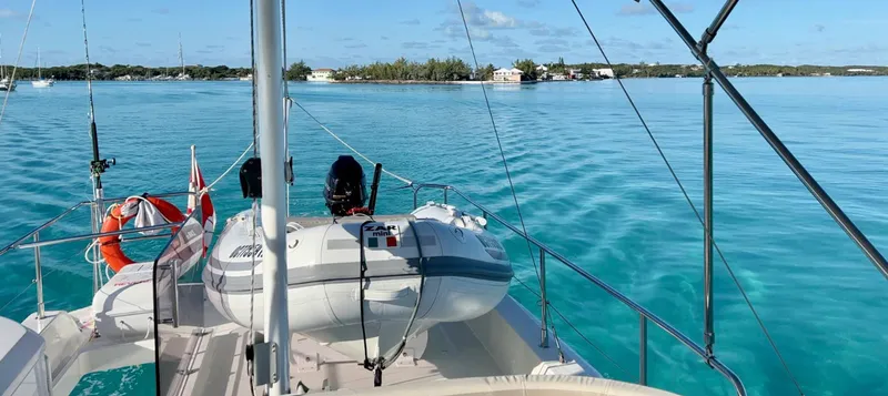 Libertad Yacht Photos Pics Beneteau Swift Trawler 44, 2020 model, cruising on clear turquoise waters near a distant shoreline.