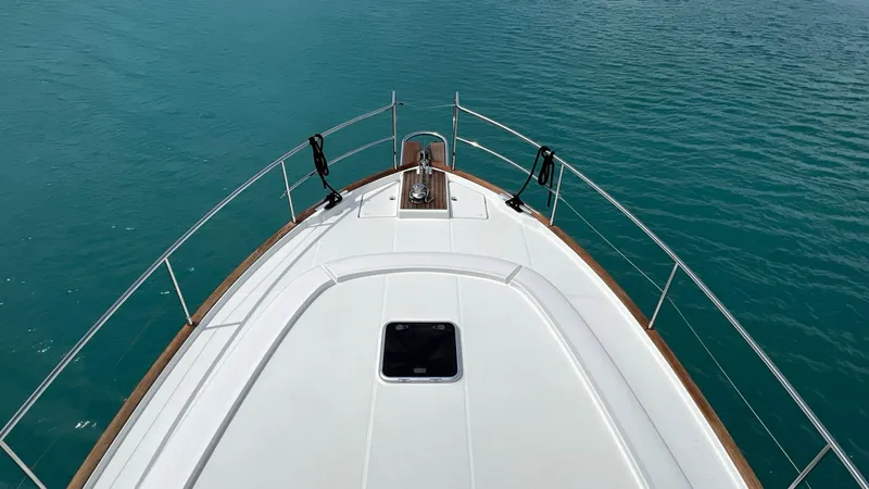 Libertad Yacht Photos Pics Bow view of 2020 Beneteau Swift Trawler 44 on calm blue water.