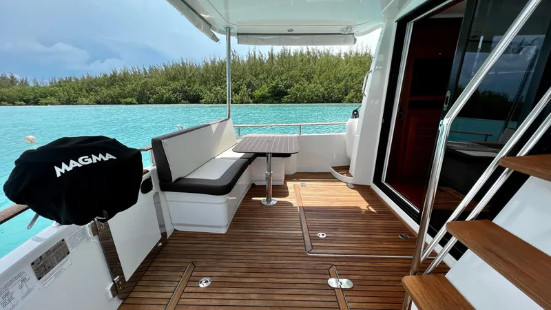 Libertad Yacht Photos Pics 2020 Beneteau Swift Trawler 44 deck with seating, table, and scenic water view.