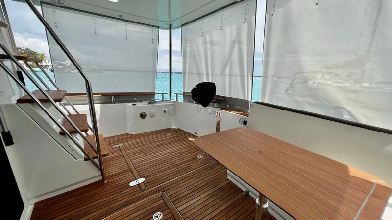 Libertad Yacht Photos Pics Beneteau Swift Trawler 44, 2020 model, featuring a spacious wooden deck and seating area.