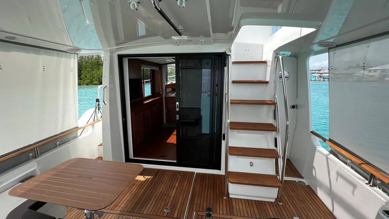 Libertad Yacht Photos Pics 2020 Beneteau Swift Trawler 44, rear deck view with stairs and sliding door.