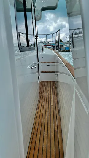 Libertad Yacht Photos Pics 2020 Beneteau Swift Trawler 44, side deck view with wooden flooring and railing.