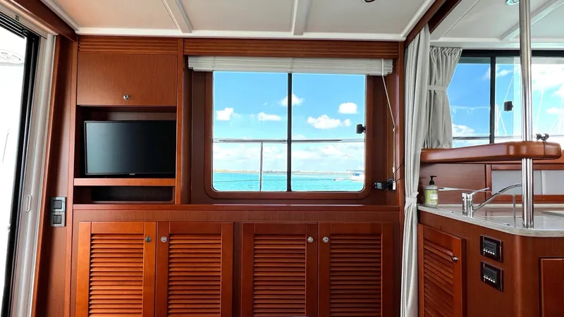 Libertad Yacht Photos Pics Interior of 2020 Beneteau Swift Trawler 44 with wooden cabinetry and ocean view.
