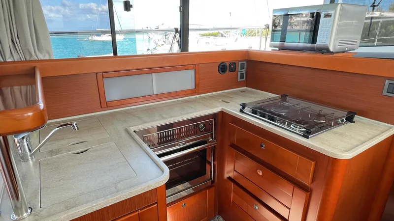 Libertad Yacht Photos Pics Modern kitchen in 2020 Beneteau Swift Trawler 44 with stove, oven, and microwave.