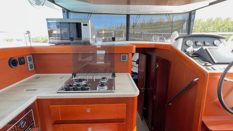 Libertad Yacht Photos Pics 2020 Beneteau Swift Trawler 44 interior with kitchen and navigation area.