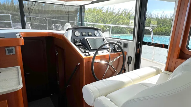 Libertad Yacht Photos Pics 2020 Beneteau Swift Trawler 44 helm with modern controls and comfortable seating.