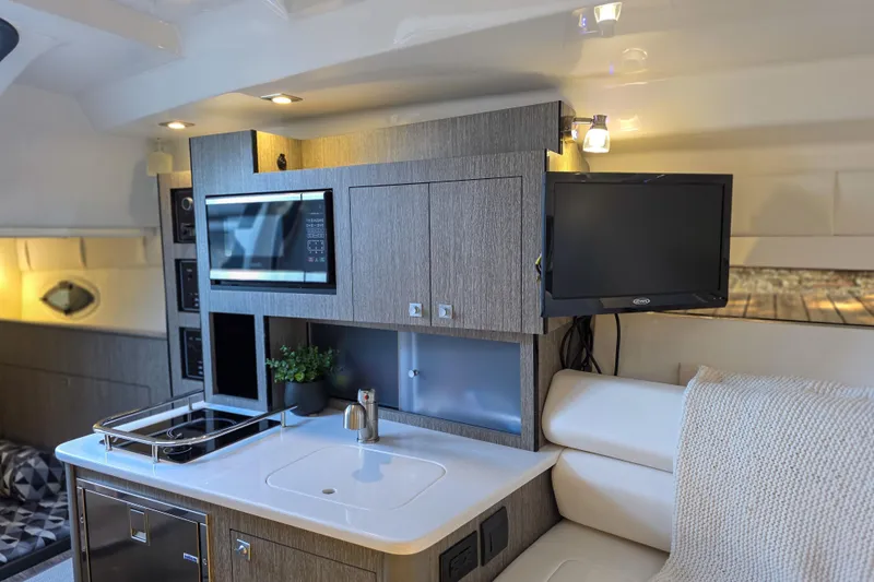  Yacht Photos Pics Luxurious interior of 2022 Monterey 295 Sport Yacht with modern kitchen and entertainment area.