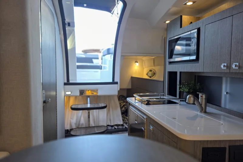  Yacht Photos Pics Interior of 2022 Monterey 295 Sport Yacht featuring modern kitchen and seating area.