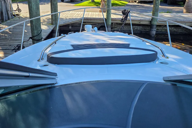  Yacht Photos Pics 2022 Monterey 295 Sport Yacht bow view at dock, featuring sleek design and railing.