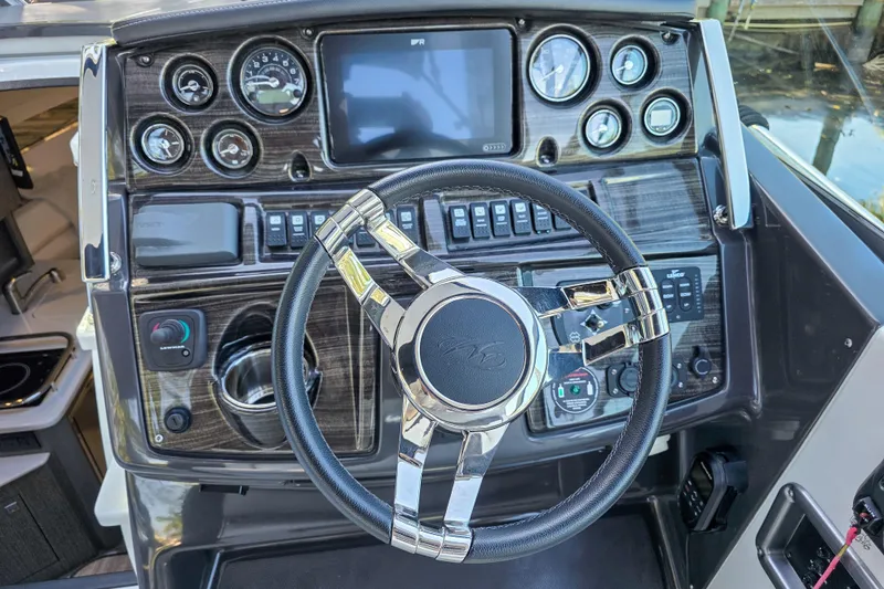  Yacht Photos Pics Dashboard of 2022 Monterey 295 Sport Yacht with steering wheel and control panel.