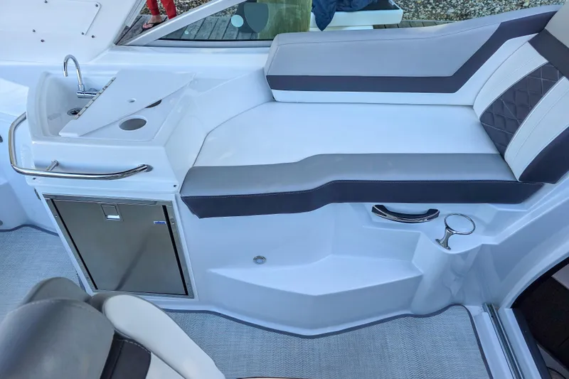  Yacht Photos Pics 2022 Monterey 295 Sport Yacht interior with sleek seating and compact kitchenette.