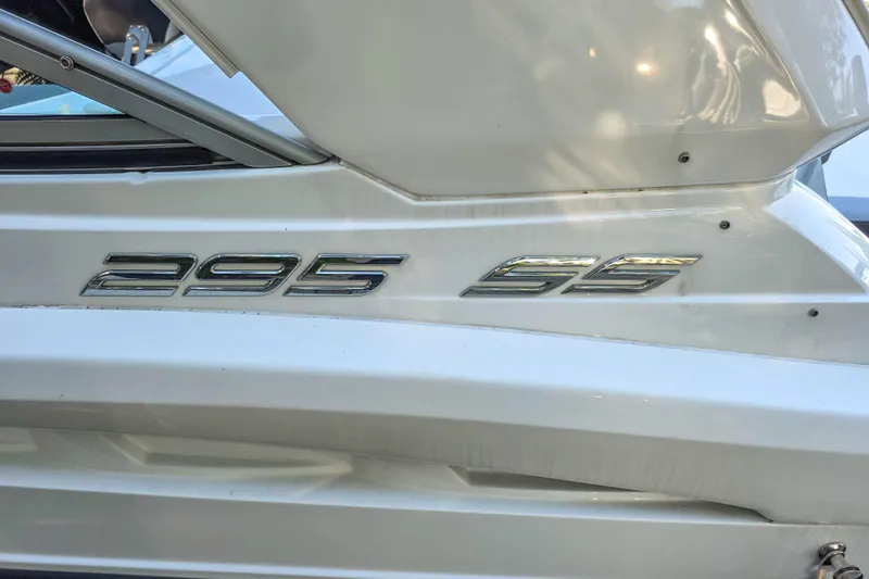  Yacht Photos Pics 2022 Monterey 295 Sport Yacht emblem on white boat exterior.