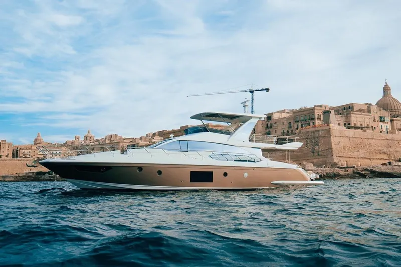  Yacht Photos Pics Luxury 2017 Azimut 66 yacht cruising near historic coastal architecture.