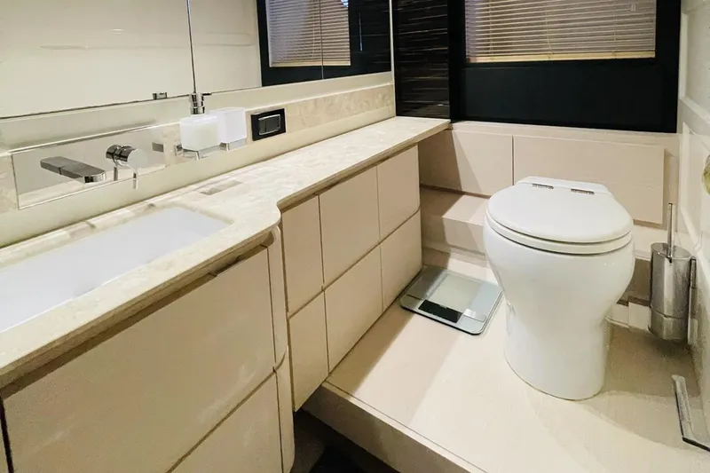  Yacht Photos Pics Luxurious bathroom in 2017 Azimut 66 yacht with modern fixtures and elegant design.