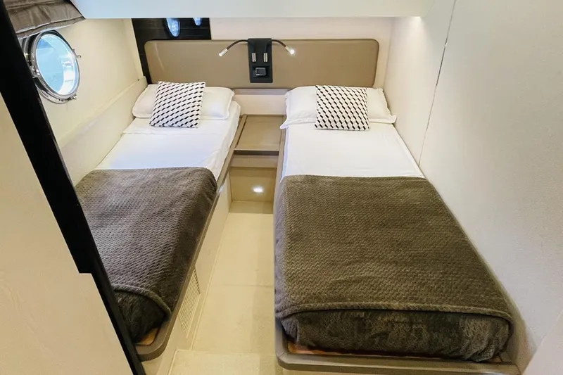  Yacht Photos Pics Twin cabin interior of 2017 Azimut 66 yacht with modern decor and porthole window.