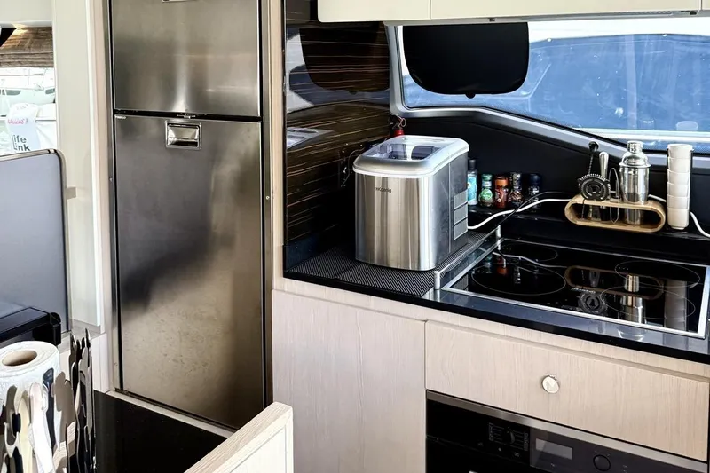  Yacht Photos Pics Modern kitchen interior of 2017 Azimut 66 yacht with stainless steel appliances.