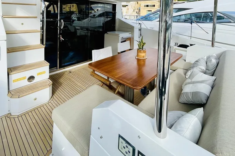  Yacht Photos Pics Luxurious 2017 Azimut 66 yacht deck with elegant seating and wooden table.
