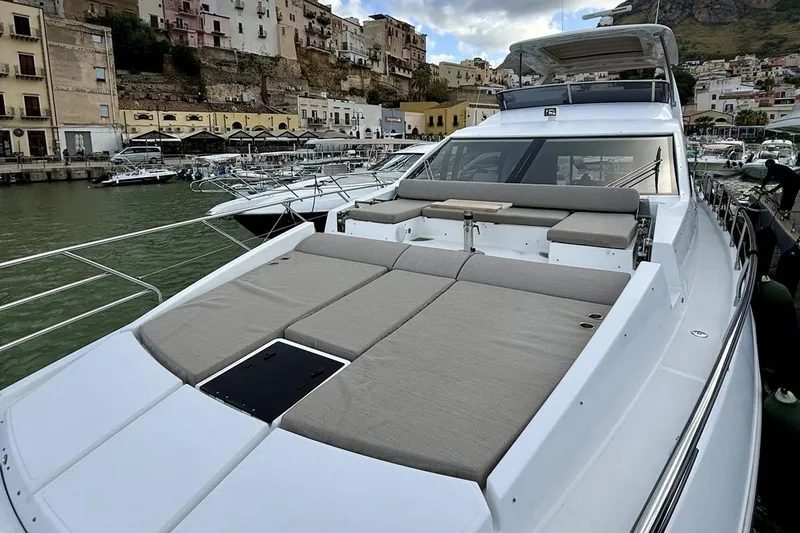  Yacht Photos Pics 2017 Azimut 66 yacht with spacious deck, docked in a scenic harbor.