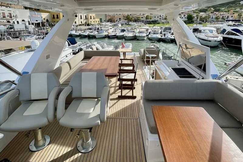  Yacht Photos Pics Luxurious 2017 Azimut 66 yacht interior with elegant seating and dining area in a marina setting.