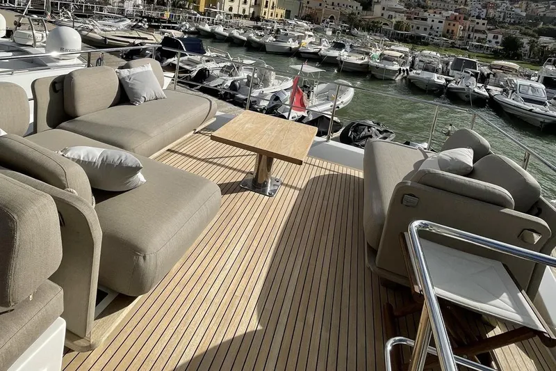  Yacht Photos Pics Luxurious deck of 2017 Azimut 66 yacht with comfortable seating and scenic marina view.