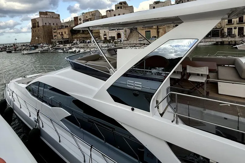  Yacht Photos Pics Luxury 2017 Azimut 66 yacht docked in scenic harbor with historic buildings.