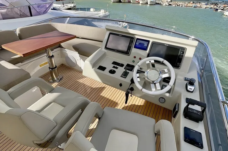  Yacht Photos Pics Luxurious 2017 Azimut 66 yacht helm with modern controls and comfortable seating.