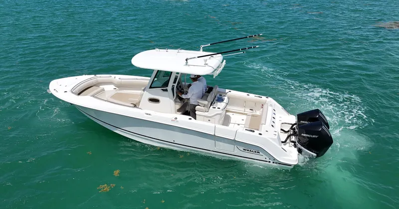 Yacht Photos Pics 2022 Boston Whaler 280 Outrage cruising on clear turquoise water.